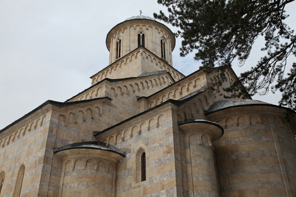 exterior from the southeast with glipse of apse and with gables and arched relief ornaments and chimera and crowned by drum and dome